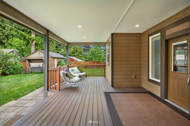 a view of a house with backyard porch and wooden floor