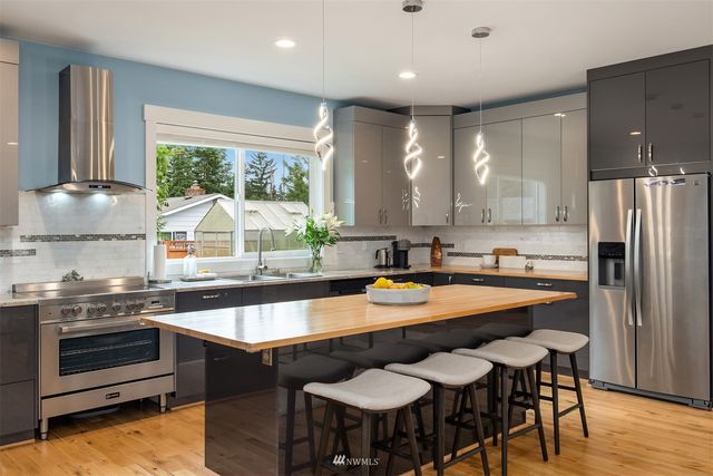 a kitchen with a stove a sink and a refrigerator