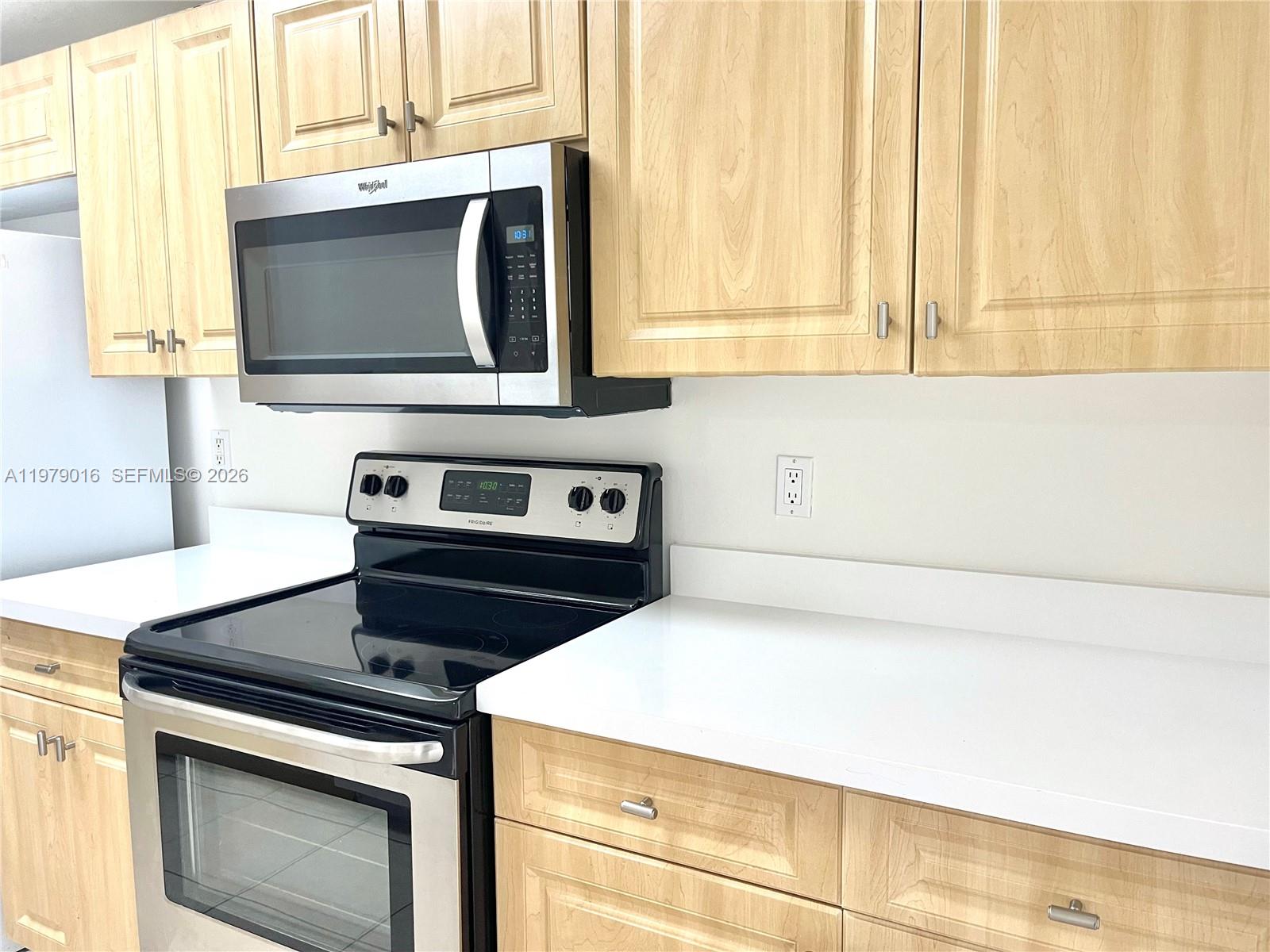 10160 Southwest 88th Street, Unit 201 Miami, FL 33176 - Photo 16 of 43 a kitchen with a stove and a microwave