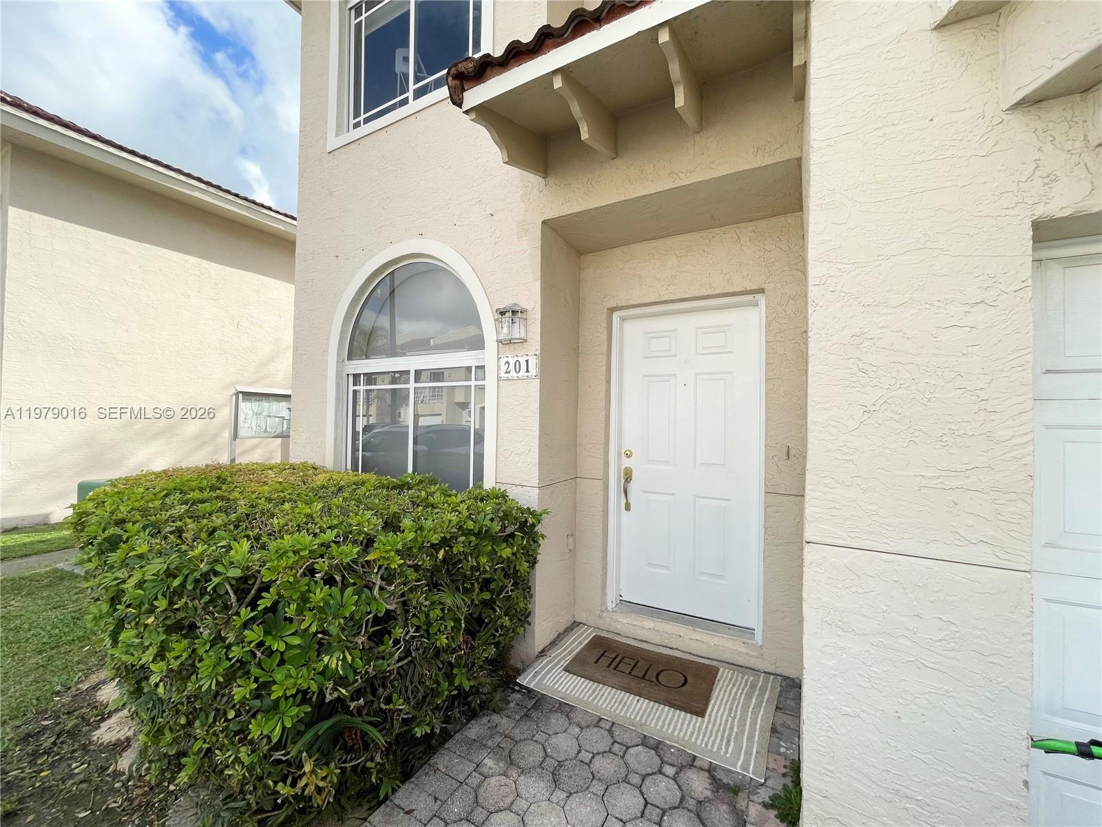 10160 Southwest 88th Street, Unit 201 Miami, FL 33176 - Photo 2 of 43 a front view of a house with garden