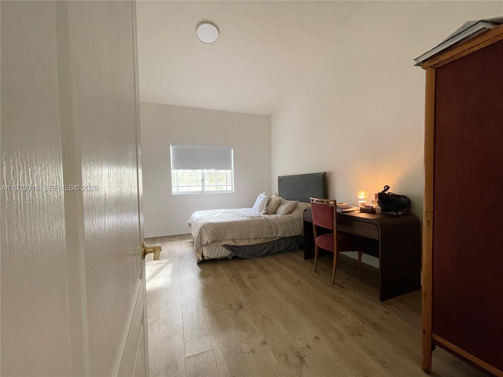 10160 Southwest 88th Street, Unit 201 Miami, FL 33176 - Photo 22 of 43 a bedroom with a bed and a window