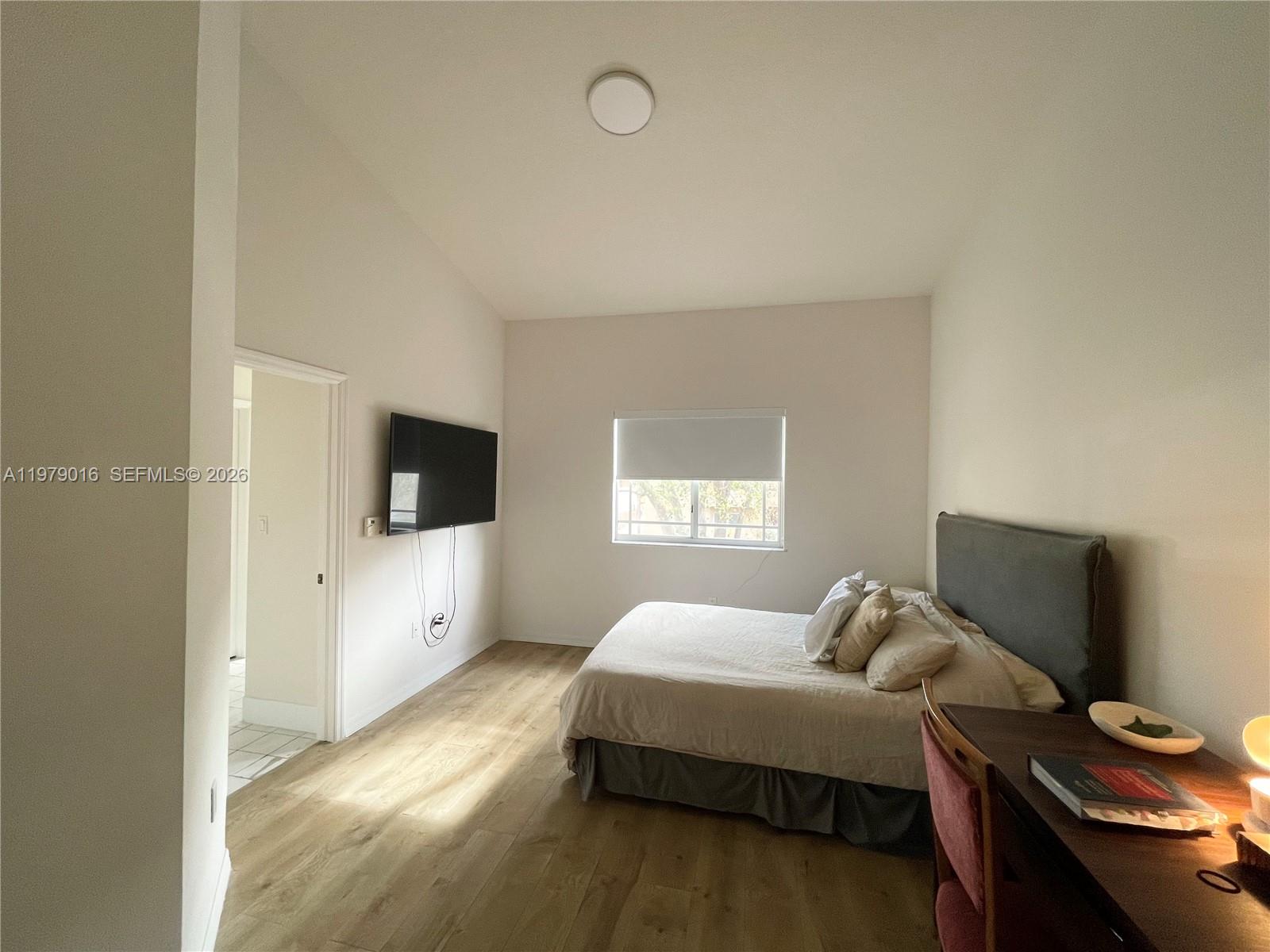 10160 Southwest 88th Street, Unit 201 Miami, FL 33176 - Photo 23 of 43 a bedroom with a bed and a flat screen tv