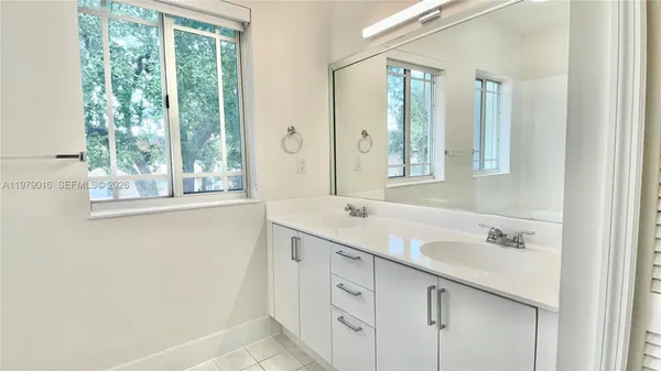 a bathroom with a sink double vanity and a mirror