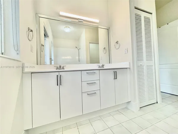 wooden floor with white cabinets