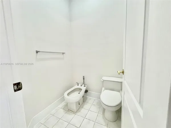 a white toilet sitting next to a bathroom sink