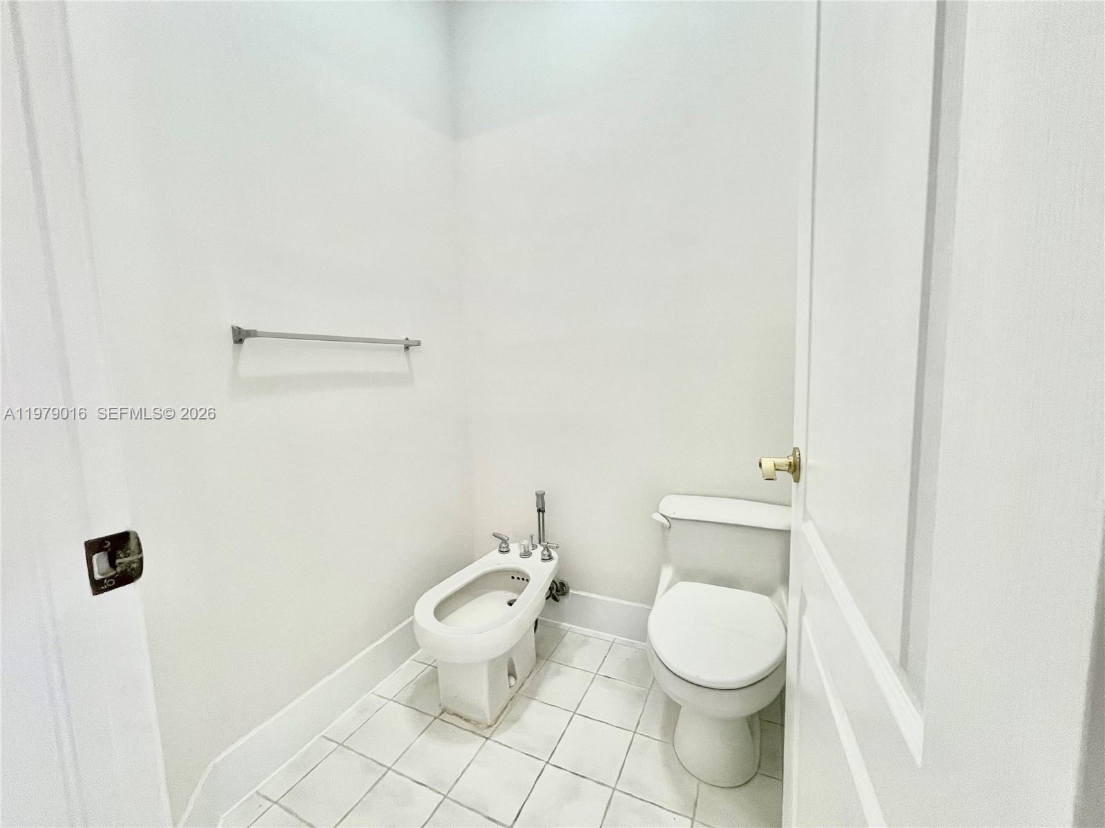 10160 Southwest 88th Street, Unit 201 Miami, FL 33176 - Photo 27 of 43 a white toilet sitting next to a bathroom sink