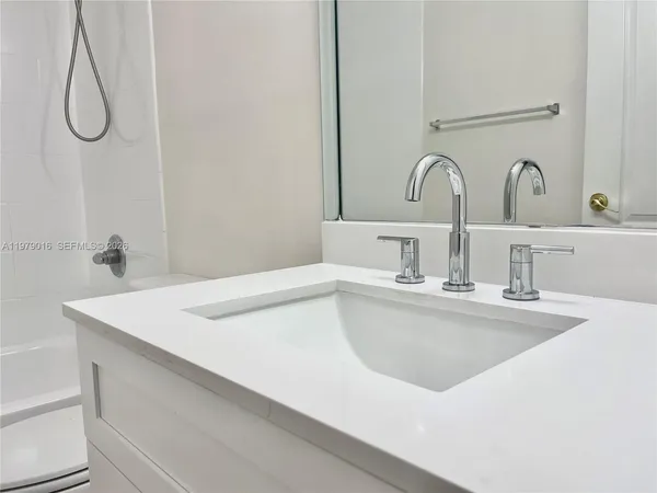 a view of kitchen with furniture and refrigerator