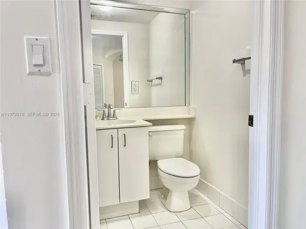 a bathroom with a sink shower and a mirror