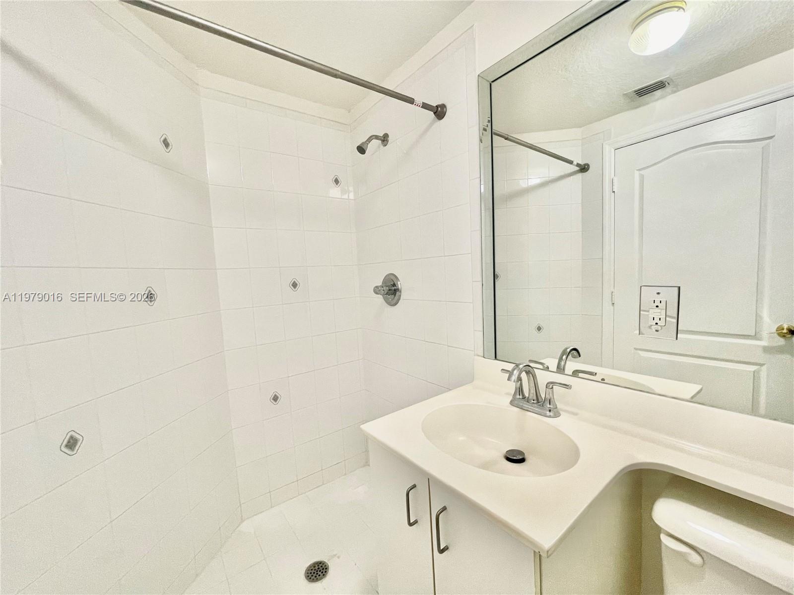 10160 Southwest 88th Street, Unit 201 Miami, FL 33176 - Photo 41 of 43 a bathroom with a sink shower and a mirror