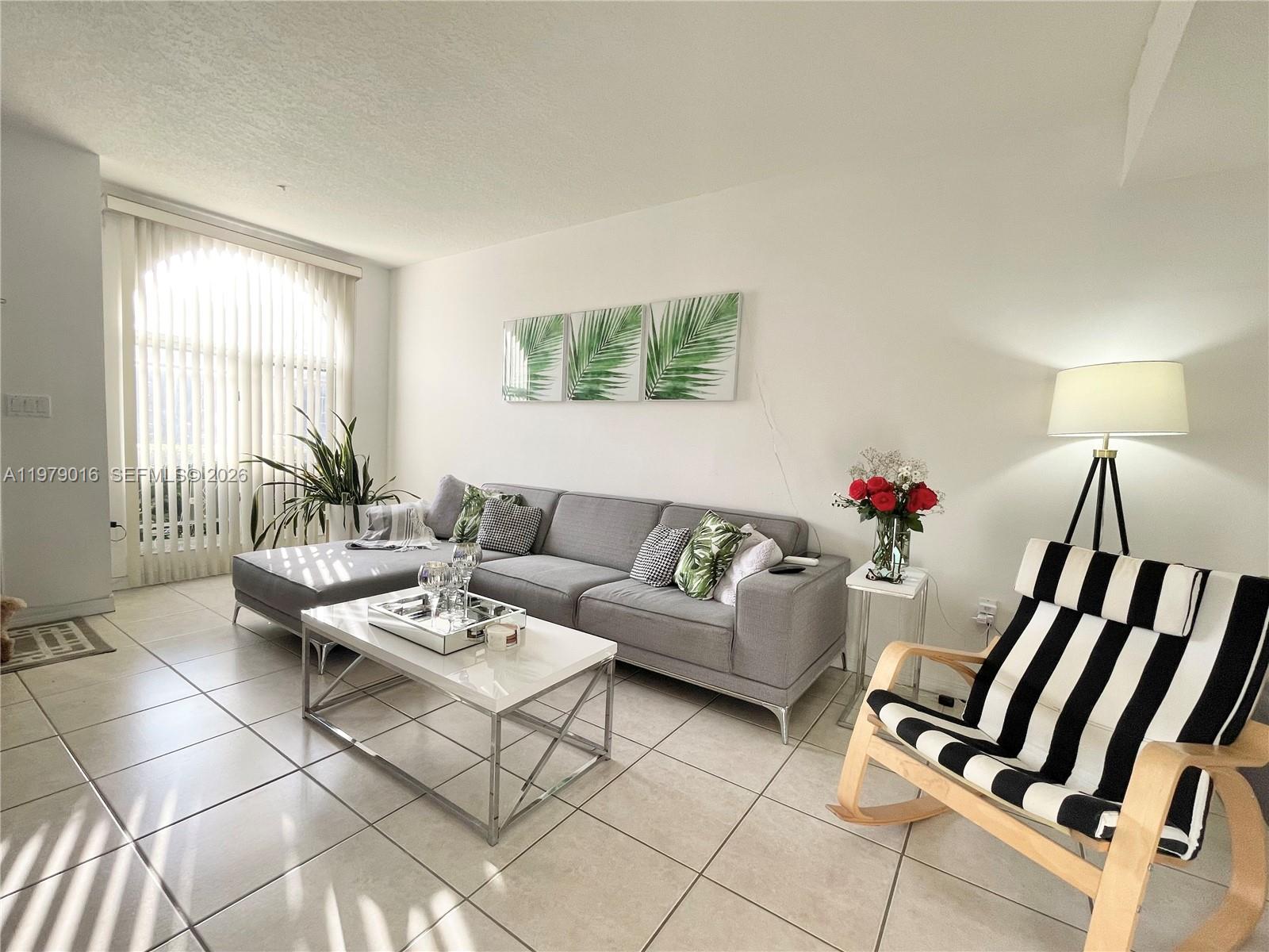 10160 Southwest 88th Street, Unit 201 Miami, FL 33176 - Photo 5 of 43 a living room with furniture and wooden floor
