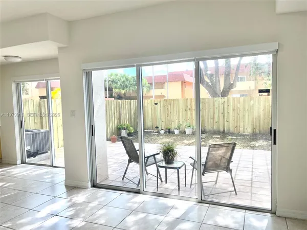 a living room with furniture and large windows