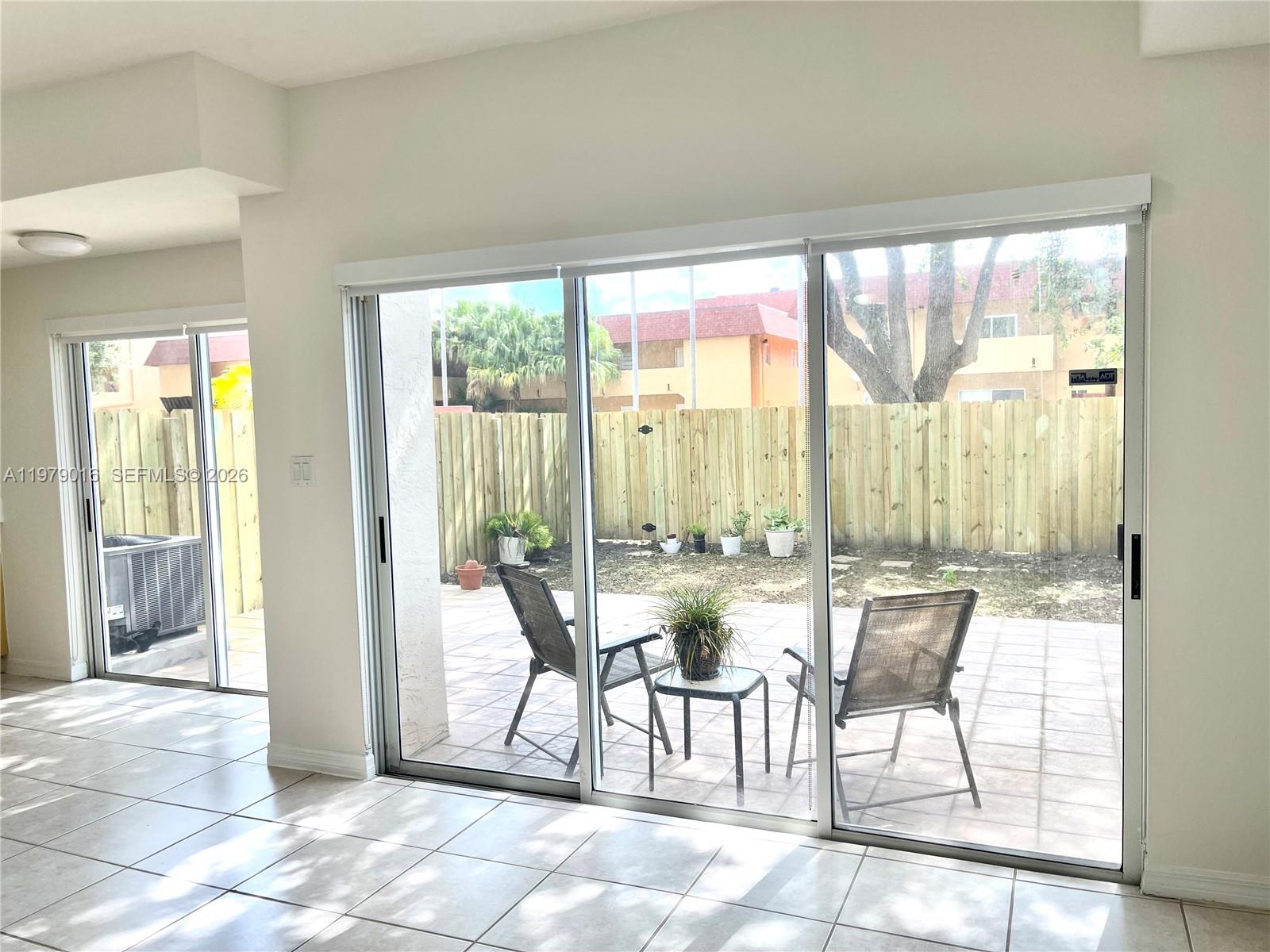 10160 Southwest 88th Street, Unit 201 Miami, FL 33176 - Photo 8 of 43 a living room with furniture and large windows