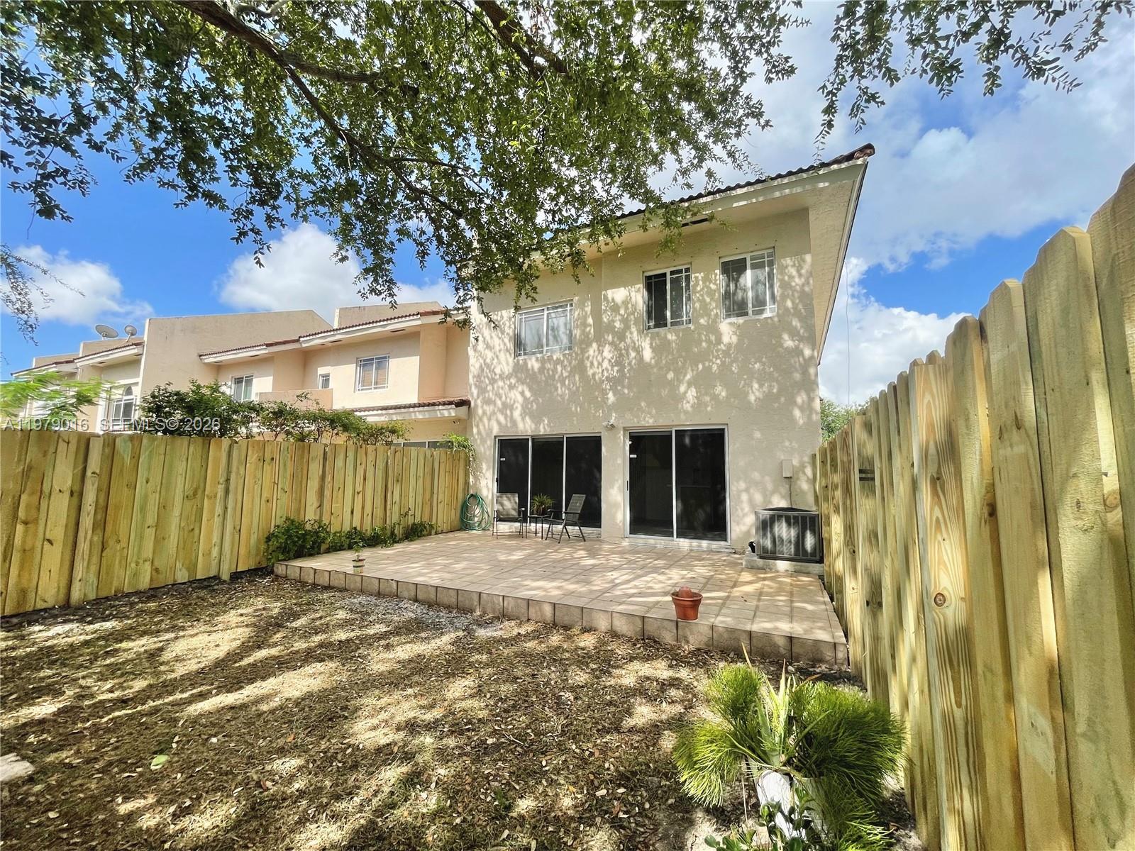 10160 Southwest 88th Street, Unit 201 Miami, FL 33176 - Photo 10 of 43 a front view of a house with a yard