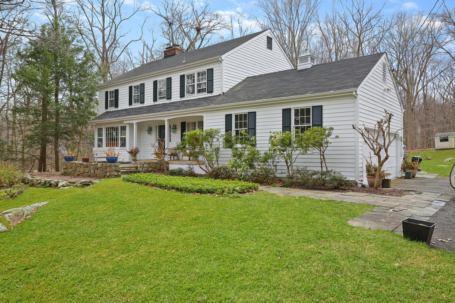 a front view of house with yard and green space