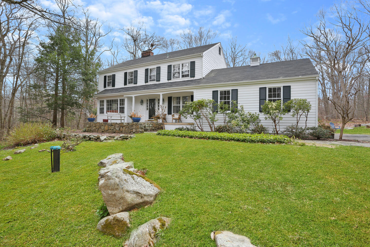 190 Briscoe Road New Canaan, CT 06840 - Photo 18 of 21 a front view of a house with a yard table and chairs
