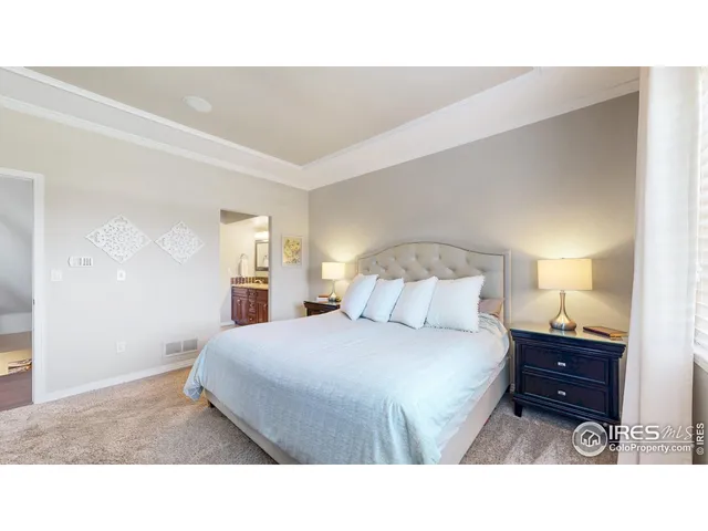 a bedroom with a bed and a night stand