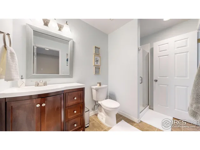 a bathroom with a sink double vanity and a toilet
