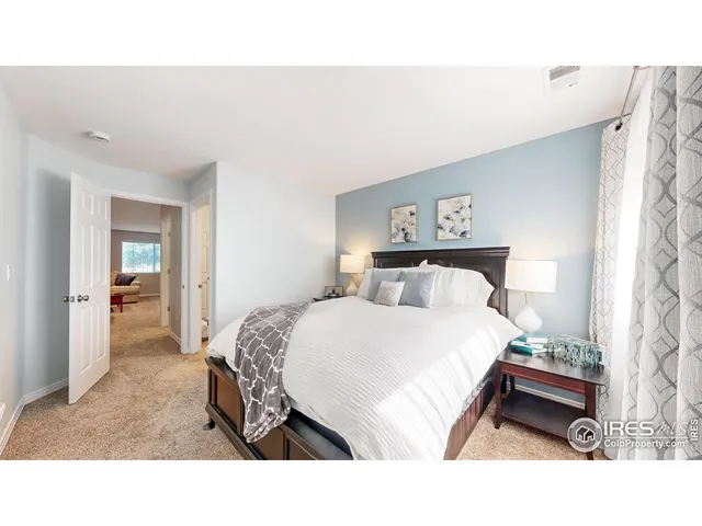 a bedroom with a bed and a painting