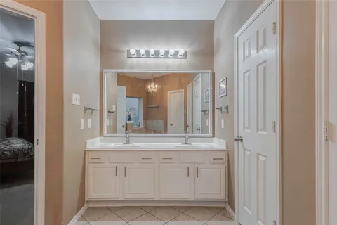 a bathroom with a double vanity sink and a mirror