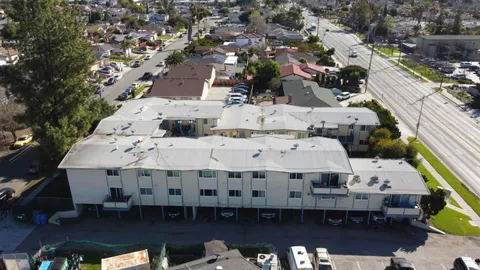 a view of a roof deck with couches and wooden floor