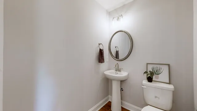 a bathroom with a sink mirror and toilet