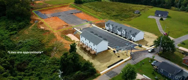 an aerial view of a residential houses with outdoor space