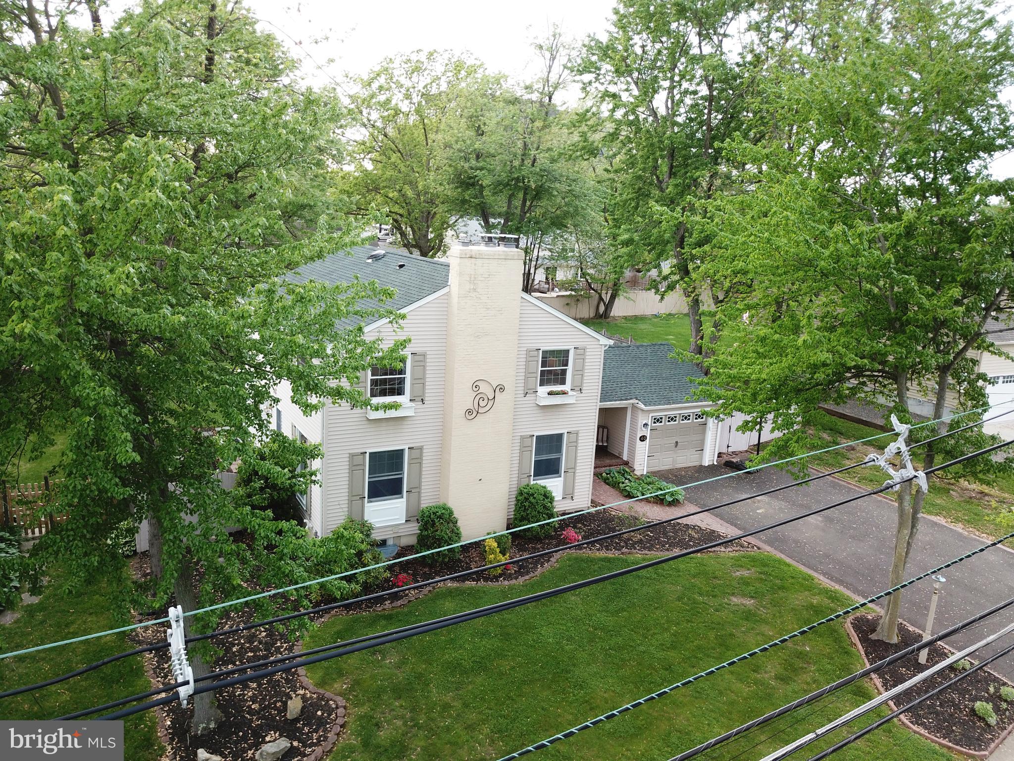 40 Covered Bridge Road Cherry Hill, NJ 08034 - Photo 50 of 52 a view of a white house with a yard and sitting area