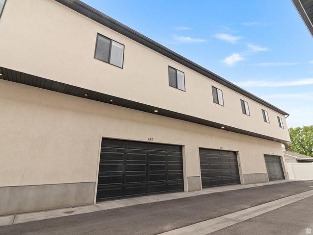 130 East 7085th South, Unit 3 Midvale, UT 84047 - Photo 27 of 30 View of side of property featuring stucco siding and a garage