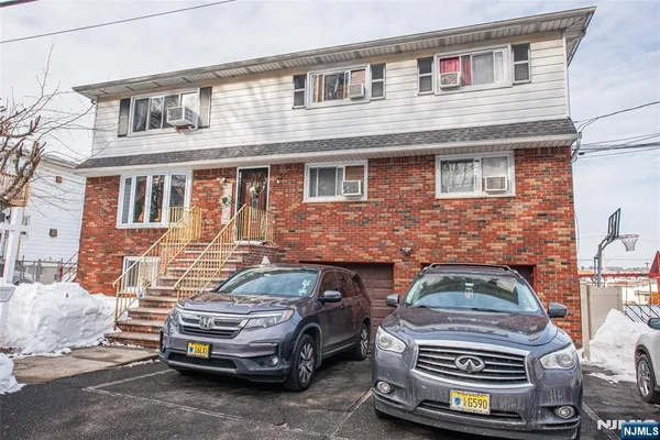 a front view of a house with parking space