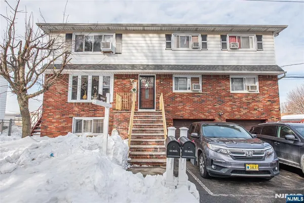 a front view of a house with parking space