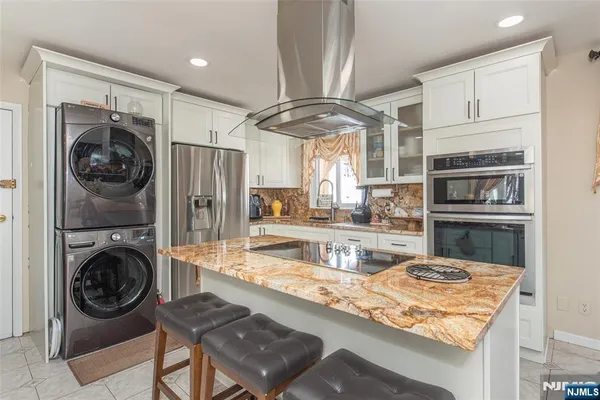 a kitchen with a refrigerator and a sink