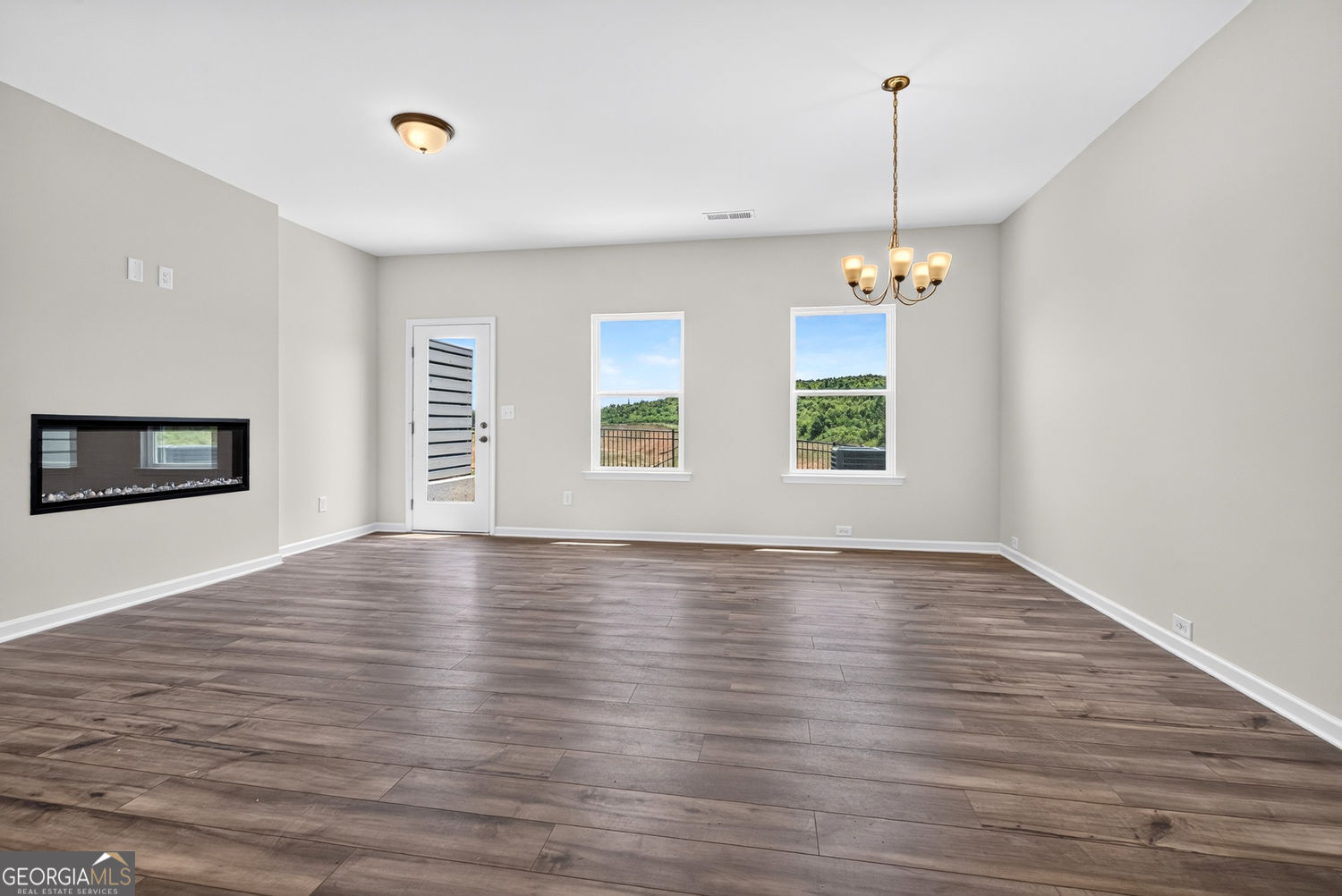 155 Oconee Road, Unit 252 Cartersville, GA 30120 - Photo 5 of 39 a view of an empty room with window and wooden floor