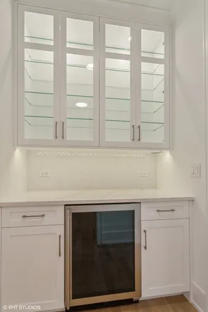 a view of a livingroom with a fireplace a ceiling fan and window