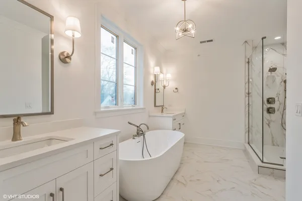 a bathroom with a toilet sink vanity and shower
