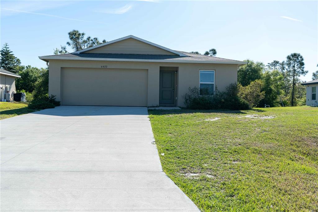 6422 Towhlen Road North Port, FL 34291 - Photo 1 of 1 a front view of a house with a yard and garage