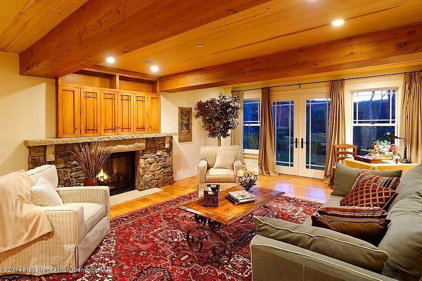 501 Greenfield Road Basalt, CO 81621 - Photo 22 of 36 a living room with furniture a fireplace and a flat screen tv