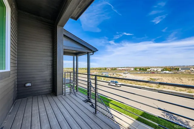 a view of a balcony with wooden floor and outdoor space