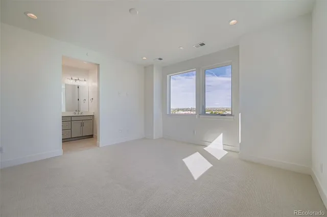 an empty room with windows and entrance