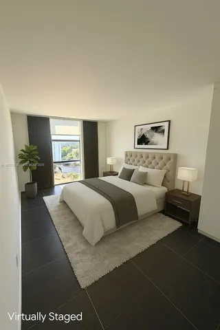 a bedroom with a large bed and a couch