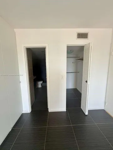 a view of storage and utility room with a door