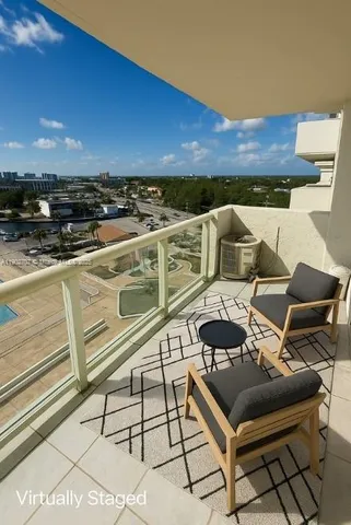 a view of a balcony with furniture and an outdoor space