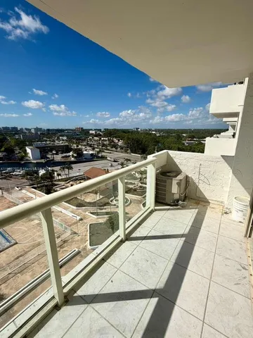 a view of a terrace with wooden floor and city view