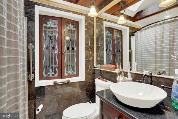 a bathroom with a toilet sink and mirror