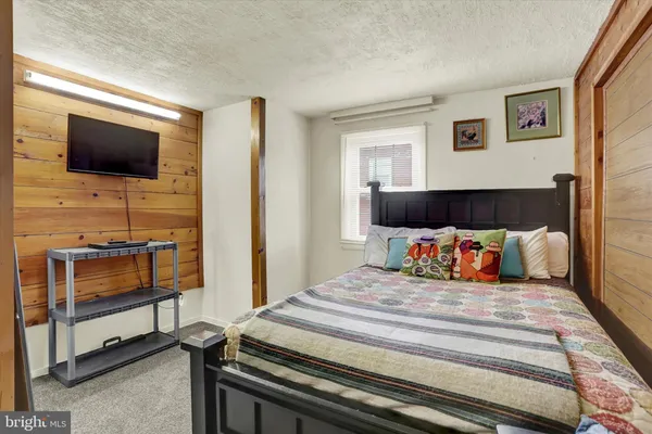a bedroom with a bed and a dresser in it