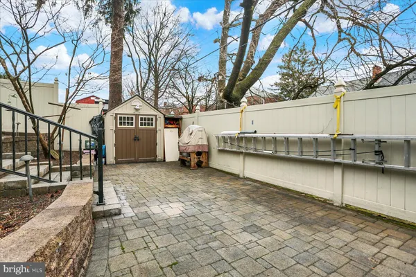 a backyard of a house with barbeque oven table and chairs