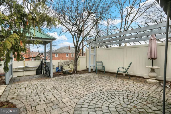 a view of a patio with table and chairs under an umbrella