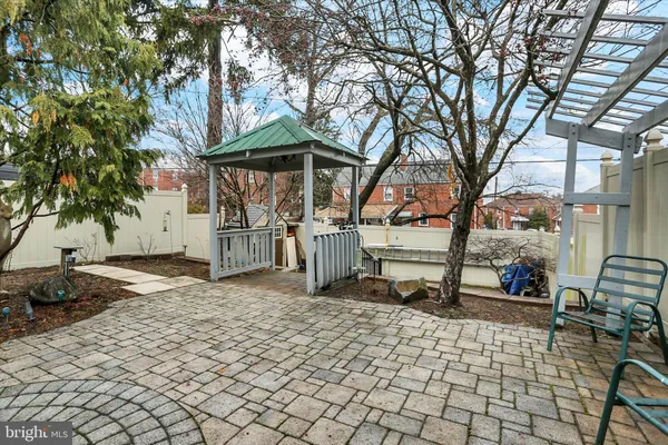 a view of a yard with a bench and some trees