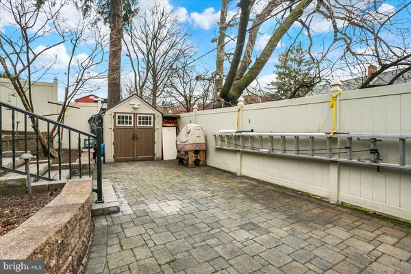 a view of a chairs and table in backyard