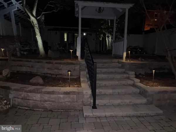 a backyard of a house with barbeque oven table and chairs