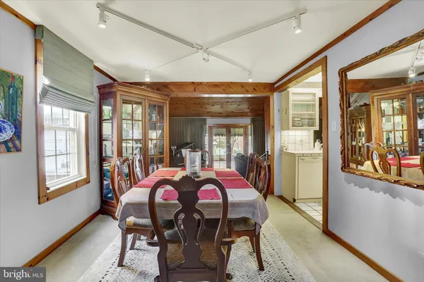 a view of a dining room with furniture and a chandelier